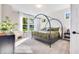 Bedroom featuring a modern bed, an accent chair, and natural light from the windows at 13406 Vickery Ridge Dr, Fishers, IN 46037