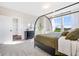 Bright bedroom with modern black metal canopy bed, carpet floors, and bright view from adjacent windows at 13406 Vickery Ridge Dr, Fishers, IN 46037