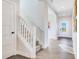 Inviting entryway with staircase, light walls, wood floors, and a view to the front door at 13406 Vickery Ridge Dr, Fishers, IN 46037