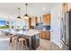 Open kitchen boasts an island with seating, stainless appliances, and wood flooring at 13406 Vickery Ridge Dr, Fishers, IN 46037