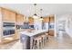 Bright kitchen features stainless steel appliances, center island with seating, and wood cabinets at 13406 Vickery Ridge Dr, Fishers, IN 46037