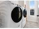 Convenient laundry area featuring modern, front-load washer and dryer units and a window at 13406 Vickery Ridge Dr, Fishers, IN 46037