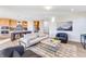 Open-concept living room with modern furnishings, stylish decor, and seamless flow to the kitchen at 13406 Vickery Ridge Dr, Fishers, IN 46037