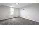Attic bedroom with gray carpet, a window, and white walls at 1418 Olive St, Indianapolis, IN 46203