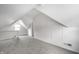Spacious attic with gray carpet and white walls, with sloped ceilings and bright natural light at 1418 Olive St, Indianapolis, IN 46203