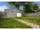 Backyard view featuring fenced yard, brick path and a gray garage at 1418 Olive St, Indianapolis, IN 46203