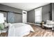 Bedroom featuring a barn door, soft gray walls, and a white bed at 1418 Olive St, Indianapolis, IN 46203