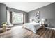 Cozy bedroom with hardwood floors, a large window, and neutral decor at 1418 Olive St, Indianapolis, IN 46203