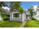 Inviting gray home with freshly cut grass and a landscaped flowerbed enhancing its charm at 1418 Olive St, Indianapolis, IN 46203