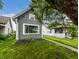 Gray home with green grass and a beautiful tree creating a peaceful outdoor setting at 1418 Olive St, Indianapolis, IN 46203