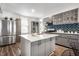 Modern kitchen featuring gray cabinetry, a center island with seating, and stainless steel appliances at 1418 Olive St, Indianapolis, IN 46203
