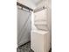 Laundry area with stacked washer and dryer and a sliding barn door at 1418 Olive St, Indianapolis, IN 46203
