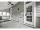 Enclosed sunroom featuring white frame windows, fan and access door at 1418 Olive St, Indianapolis, IN 46203