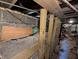 Unfinished basement with concrete walls and exposed wooden support beams at 1433 N Denny St, Indianapolis, IN 46201