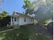 Charming single-story home featuring mature trees and a cozy front porch at 1433 N Denny St, Indianapolis, IN 46201
