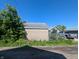 View of the detached garage exterior, showing brick wall and back of house at 1433 N Denny St, Indianapolis, IN 46201