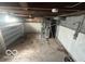 This is a view of the basement, including plumbing, exposed beams and concrete floors at 1527 Main St, Beech Grove, IN 46107