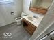 Bathroom with tile walls, including a toilet, vanity, and medicine cabinet at 1527 Main St, Beech Grove, IN 46107
