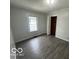 This is a bedroom featuring a window and hardwood style flooring at 1527 Main St, Beech Grove, IN 46107