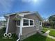 Angle view of this charming single-Gathering home with light brown siding, a cozy space to make yours! at 1527 Main St, Beech Grove, IN 46107