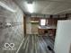 This is a view of the kitchen, including older appliances, wood cabinets and tiled walls at 1527 Main St, Beech Grove, IN 46107