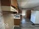 This is a view of the kitchen, including appliances, wood cabinets and a double basin sink at 1527 Main St, Beech Grove, IN 46107
