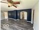 Open-concept living room featuring stylish wood-look floors and an inviting blue accent wall at 1527 Main St, Beech Grove, IN 46107
