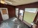 This is a view of the enclosed porch featuring multiple doors and some windows at 1527 Main St, Beech Grove, IN 46107