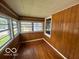 An enclosed porch with many windows, creating a bright and inviting transitional space at 1527 Main St, Beech Grove, IN 46107