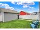 Private backyard space showcasing tidy green lawn with two Adirondack chairs and a gray siding garage at 158 Handley St, Indianapolis, IN 46222