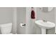Powder room features a pedestal sink, modern fixtures, and convenient placement near the main living areas at 158 Handley St, Indianapolis, IN 46222