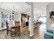 Open-concept dining room showcases hardwood floors, modern light fixture, and seamless flow to the kitchen and living area at 158 Handley St, Indianapolis, IN 46222