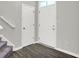 Inviting entryway with wood-look flooring, staircase, and a bright front door welcomes guests into the home at 158 Handley St, Indianapolis, IN 46222