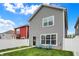 View of home with light gray siding, neat landscaping, white fence, and inviting blue Adirondack chairs at 158 Handley St, Indianapolis, IN 46222