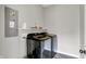 Laundry room equipped with modern appliances, overhead shelving, and ample space for laundry tasks at 158 Handley St, Indianapolis, IN 46222