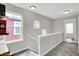 Staircase featuring gray carpet and neutral-toned walls with multiple windows at 158 Handley St, Indianapolis, IN 46222