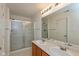 Bathroom featuring a double sink vanity, a large mirror, and a shower with glass doors at 163 Clear Branch Dr, Brownsburg, IN 46112