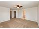 Large bedroom featuring neutral carpet, a ceiling fan, and access to closet and bathroom at 163 Clear Branch Dr, Brownsburg, IN 46112