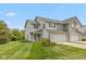 Inviting two-story townhouse featuring a lush lawn, attached garage, and neutral siding at 163 Clear Branch Dr, Brownsburg, IN 46112