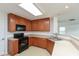 Well-lit kitchen with wood cabinetry, black appliances, and light countertops at 163 Clear Branch Dr, Brownsburg, IN 46112