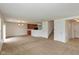 Open living space with carpet, stairs, and an adjacent kitchen area at 163 Clear Branch Dr, Brownsburg, IN 46112