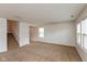 Bright living area showcasing neutral carpeting, staircase, and natural light from windows at 163 Clear Branch Dr, Brownsburg, IN 46112