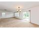 Carpeted living room with sliding glass door, multiple windows and dining area at 163 Clear Branch Dr, Brownsburg, IN 46112