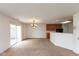 Open-concept living space featuring a sliding glass door, and adjacent kitchen and dining area at 163 Clear Branch Dr, Brownsburg, IN 46112