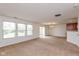 Spacious living room featuring neutral carpet, large windows, and a dining area at 163 Clear Branch Dr, Brownsburg, IN 46112