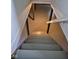 View of basement stairs leading to the lower level; wooden steps and railing at 1722 Dawson St, Indianapolis, IN 46203