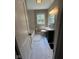 Bathroom featuring white marble floors, a black vanity, and a tiled shower/tub at 1722 Dawson St, Indianapolis, IN 46203