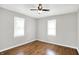This bedroom has hardwood floors, ceiling fan, neutral paint, and two windows at 1722 Dawson St, Indianapolis, IN 46203