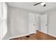 Bedroom with wood floors, ceiling fan, neutral paint and two white doors at 1722 Dawson St, Indianapolis, IN 46203