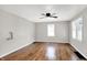 Spacious bedroom featuring refinished hardwood floors, neutral walls, and a ceiling fan with lights at 1722 Dawson St, Indianapolis, IN 46203